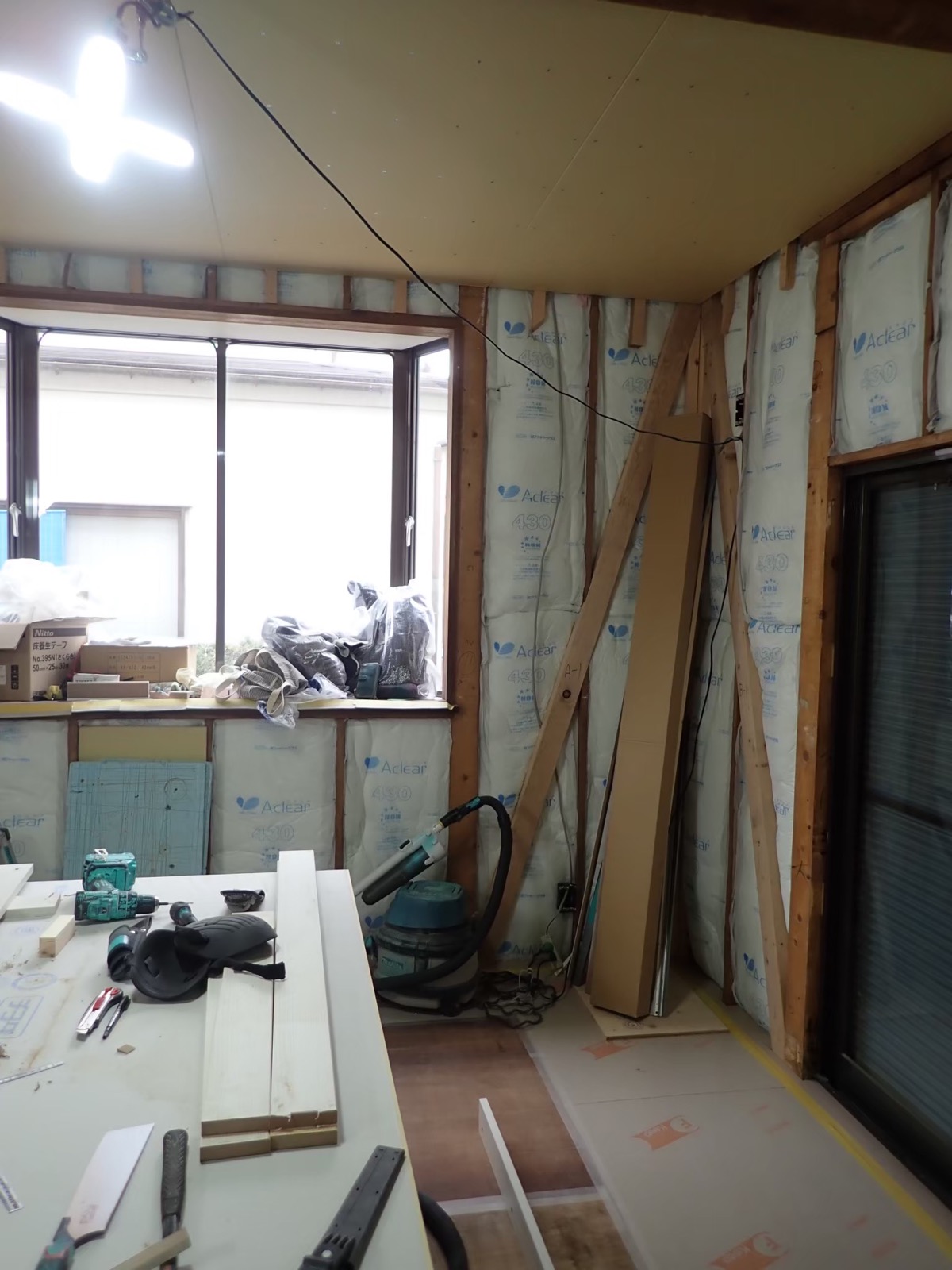 Insulation being installed in akiya walls during restoration