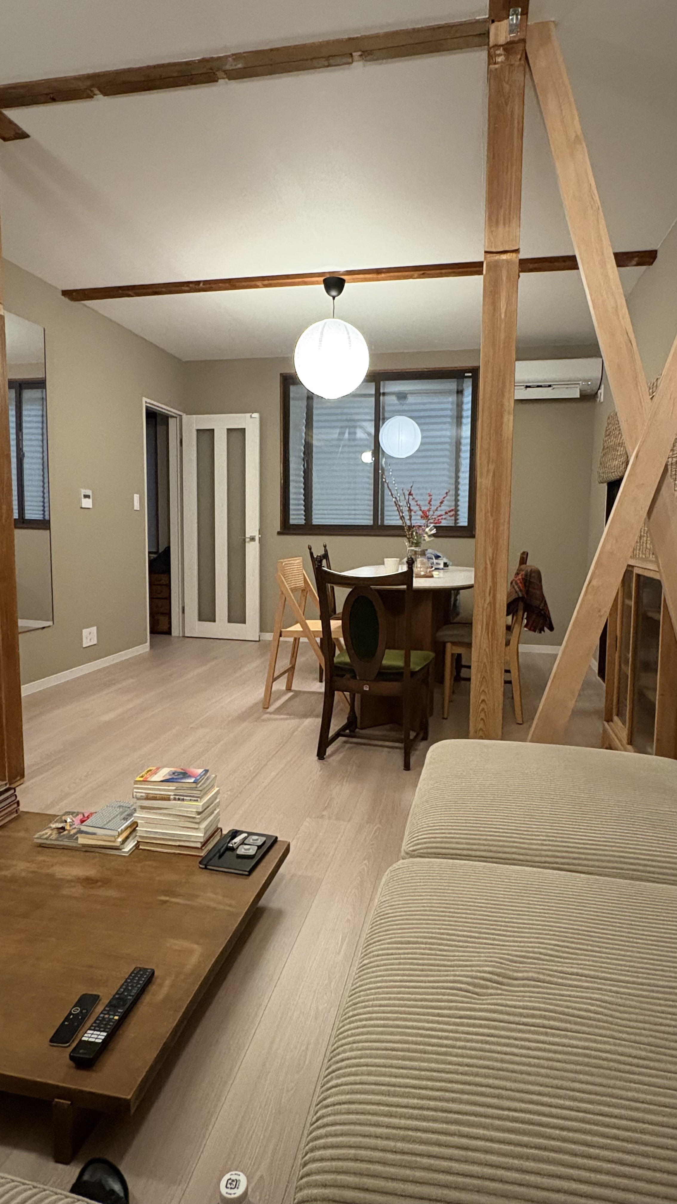 Restored akiya living room with exposed wooden beams and wabi-sabi decor