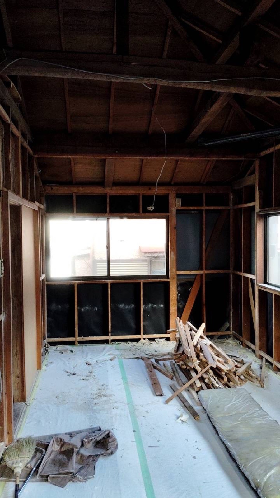 Stripped room with exposed beams during akiya demolition